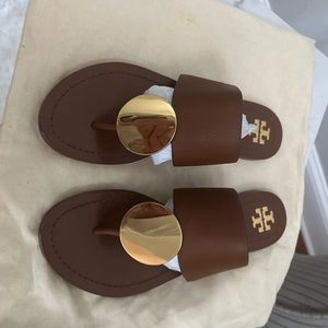 Tory Burch brown sandals with a gold medallion, size 7